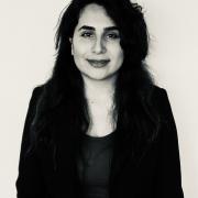 A black and white headshot of Hadis